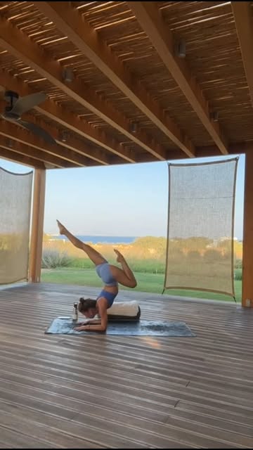 Yoga pose on a terrace with a sea view